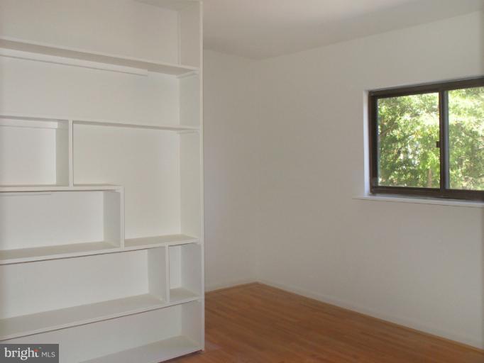 1646 Waters Edge Lane Reston, VA 20190 - Photo 26 of 30 a view of an empty room with wooden floor and cabinet