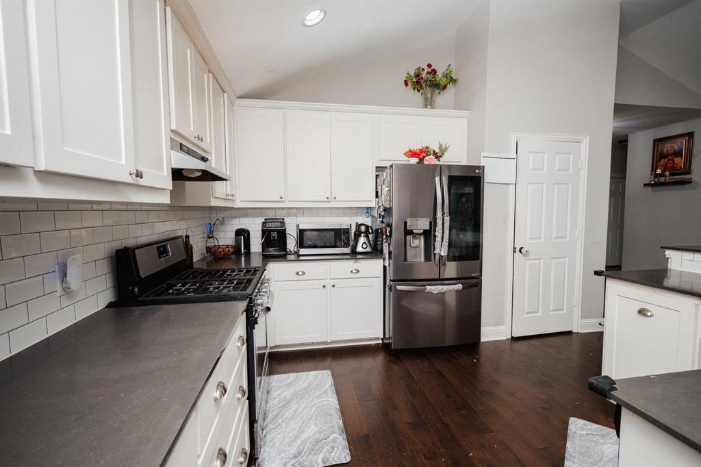 18125 Justice Lane Dallas, TX 75287 - Photo 12 of 18 a kitchen with a refrigerator and a stove top oven