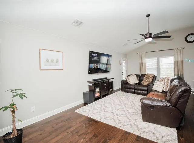 a view of a backyard with wooden fence