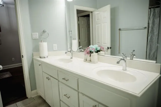 a bathroom with a double vanity sink and a mirror