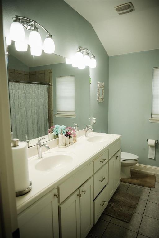 18125 Justice Lane Dallas, TX 75287 - Photo 5 of 18 a bathroom with a double vanity sink and a mirror