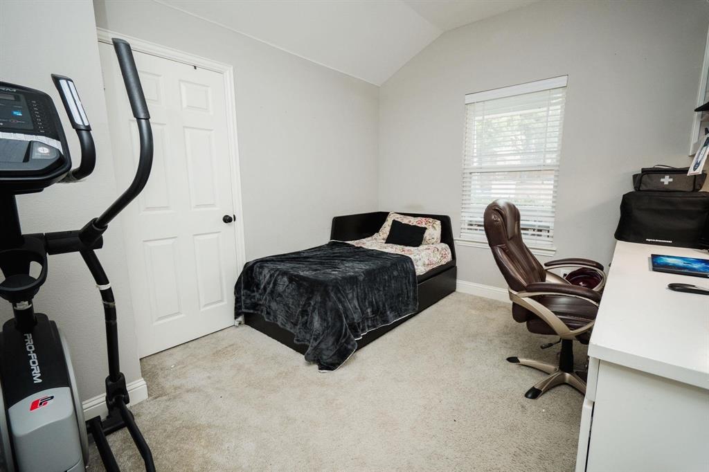 18125 Justice Lane Dallas, TX 75287 - Photo 6 of 18 a bedroom with a bed a desk chair and a window