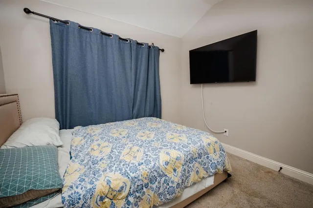 a bedroom with a bed and window