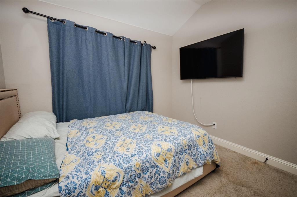 18125 Justice Lane Dallas, TX 75287 - Photo 7 of 18 a bedroom with a bed and flat screen tv