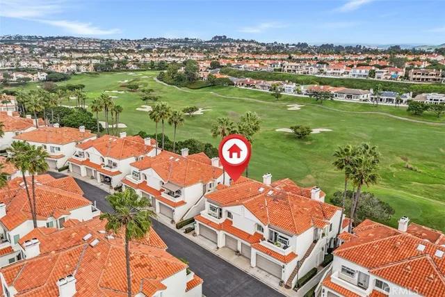 an aerial view of residential houses with outdoor space and swimming pool
