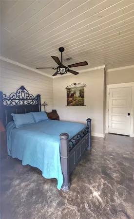a bedroom with a bed and a ceiling fan