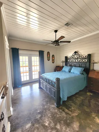 a bedroom with a bed and a large window