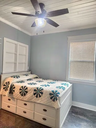 a bedroom with a bed and a window