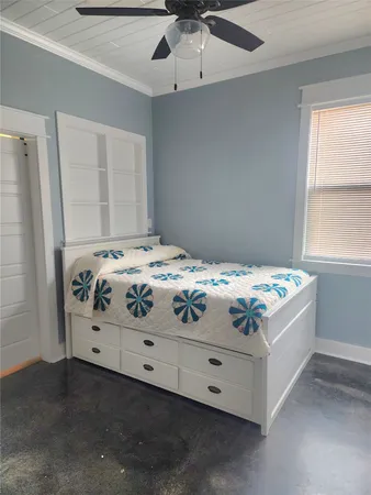 a bedroom with a bed and a window
