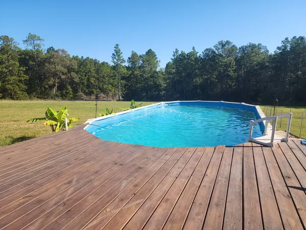a view of a wooden deck with a yard