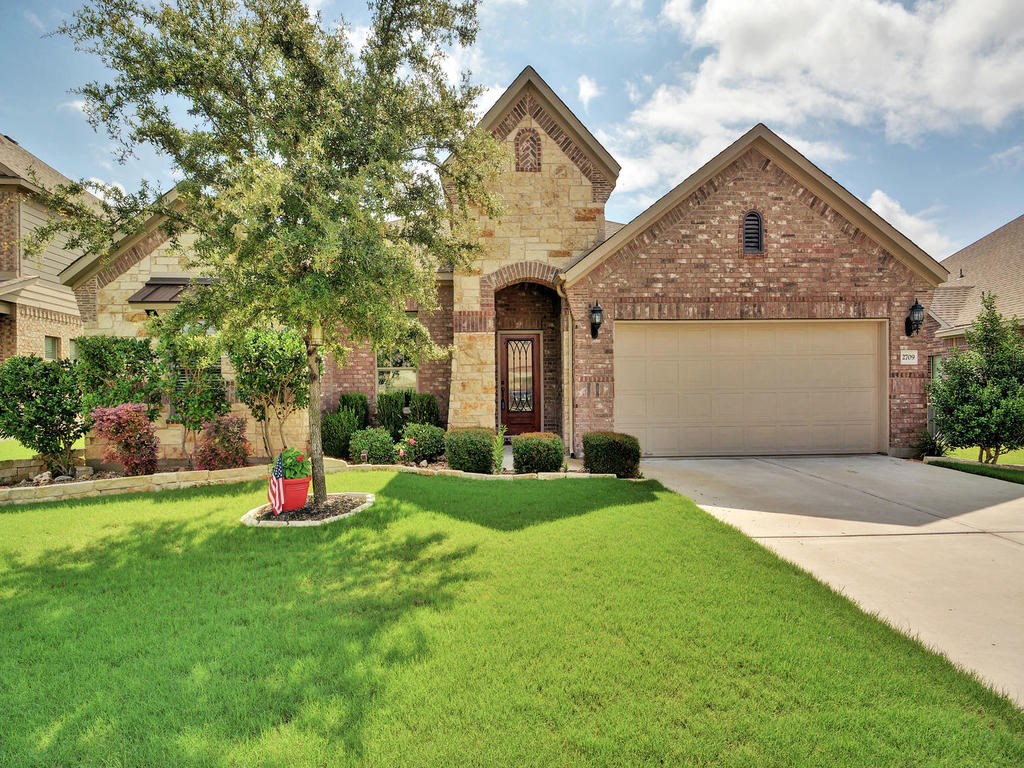 a front view of a house with a yard and garage