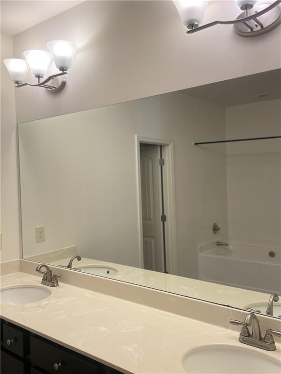 1418 Haynescrest Court, Unit 90 Grayson, GA 30017 - Photo 11 of 14 a bathroom with a sink and a mirror