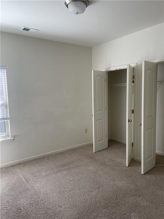 1418 Haynescrest Court, Unit 90 Grayson, GA 30017 - Photo 13 of 14 an empty room with windows and closet