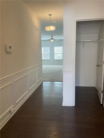 a view of a room with wooden floor and a window