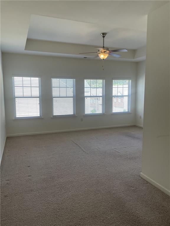 1418 Haynescrest Court, Unit 90 Grayson, GA 30017 - Photo 5 of 14 en empty room with windows and ceiling fan