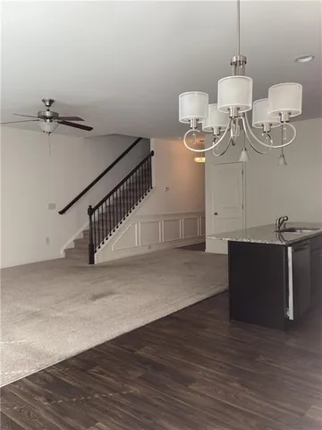 a room with gym equipment and wooden floor