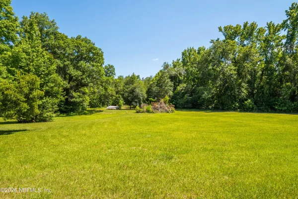 a view of outdoor space with swimming pool and trees in the background