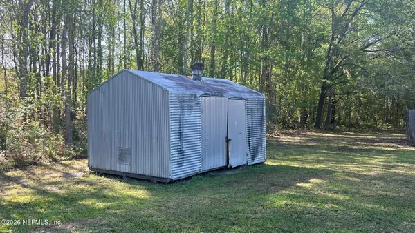 a view of a backyard with a small cabin