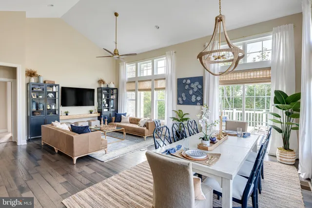 a living room with furniture chandelier and a flat screen tv