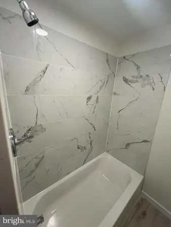 a bathroom with a bathtub and shower