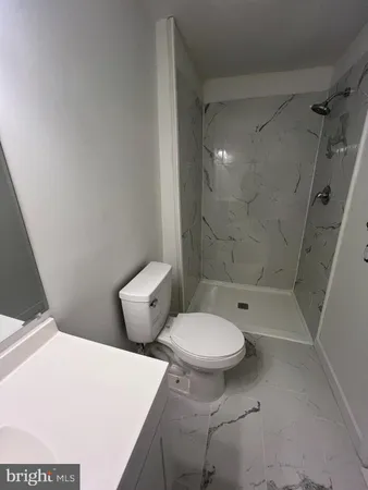 a bathroom with a toilet and a shower