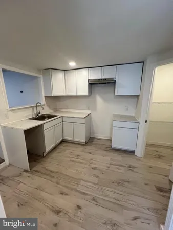 a kitchen with white cabinets and white appliances