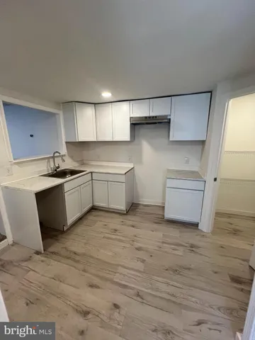 a kitchen with white cabinets and white appliances