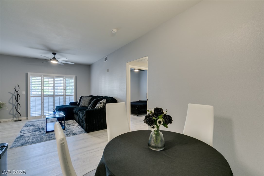7255 West Sunset Road, Unit 1103 Las Vegas, NV 89113 - Photo 25 of 35 An inviting open-concept area features light-toned flooring and a bright sliding glass door.