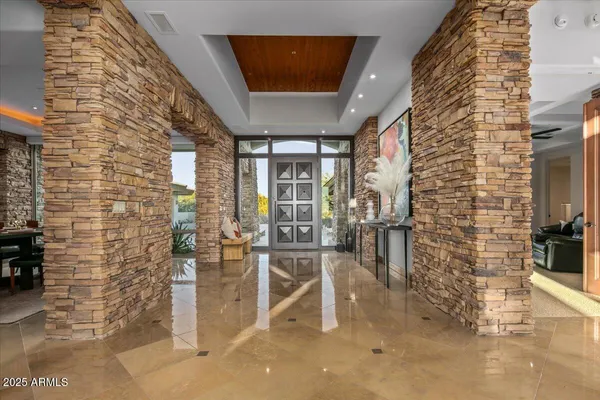 a living room with furniture and a floor to ceiling window
