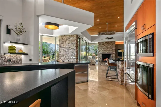 a dining room with furniture and a floor to ceiling window