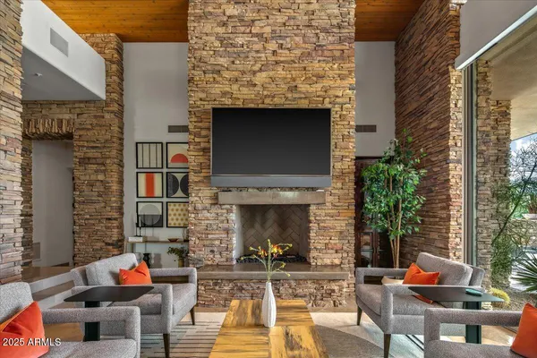 a dining room with furniture and a floor to ceiling window