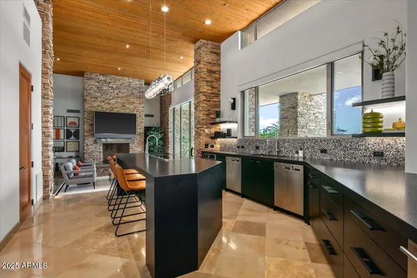 a dining room with furniture and a floor to ceiling window