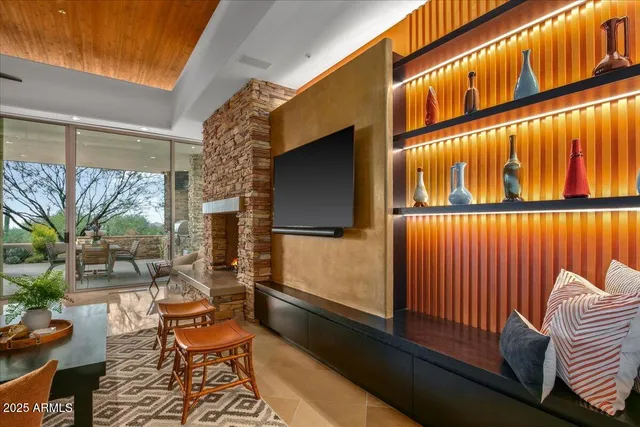 a view of a workspace with furniture and a bookshelf