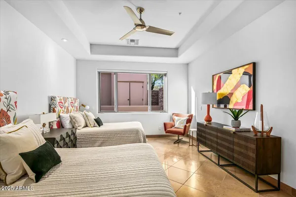 a bedroom with a bed and a large window