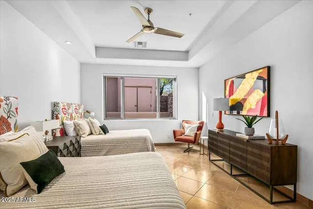 a bedroom with a bed and a large window