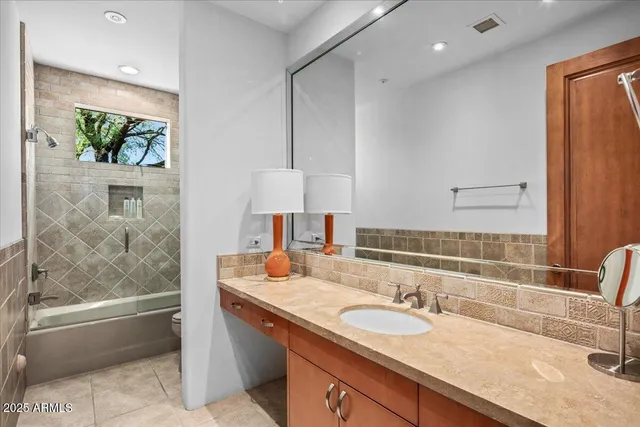 a bathroom with a sink a mirror and a bathtub