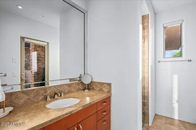 a dining room with furniture and a floor to ceiling window