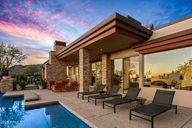 a living room with patio furniture and a potted plant