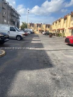 a view of street with parked cars