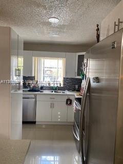 1025 West 77th Street, Unit N Hialeah, FL 33014 - Photo 11 of 30 a kitchen with a refrigerator and window