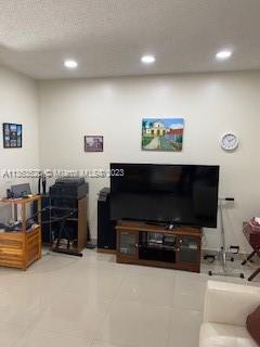 1025 West 77th Street, Unit N Hialeah, FL 33014 - Photo 14 of 30 a living room with furniture and a flat screen tv
