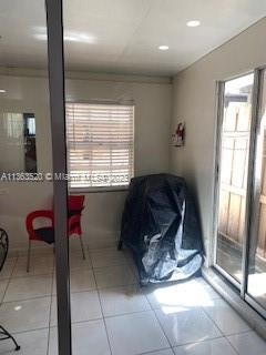 1025 West 77th Street, Unit N Hialeah, FL 33014 - Photo 16 of 30 a bathroom with a granite countertop sink a mirror and shower