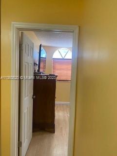 1025 West 77th Street, Unit N Hialeah, FL 33014 - Photo 17 of 30 a hallway with a dining table and chairs