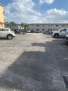 1025 West 77th Street, Unit N Hialeah, FL 33014 - Photo 2 of 30 a view of parking with cars parked