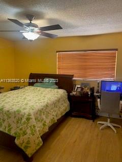 1025 West 77th Street, Unit N Hialeah, FL 33014 - Photo 22 of 30 a bed sitting in a bedroom next to a window