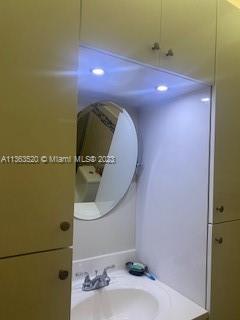 1025 West 77th Street, Unit N Hialeah, FL 33014 - Photo 26 of 30 a bathroom with a sink and a mirror