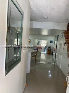 1025 West 77th Street, Unit N Hialeah, FL 33014 - Photo 6 of 30 a dining room with furniture and a glass door