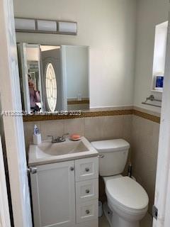 1025 West 77th Street, Unit N Hialeah, FL 33014 - Photo 8 of 30 a bathroom with a toilet sink and mirror