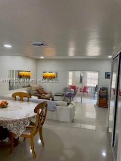 1025 West 77th Street, Unit N Hialeah, FL 33014 - Photo 9 of 30 a living room with furniture and a flat screen tv