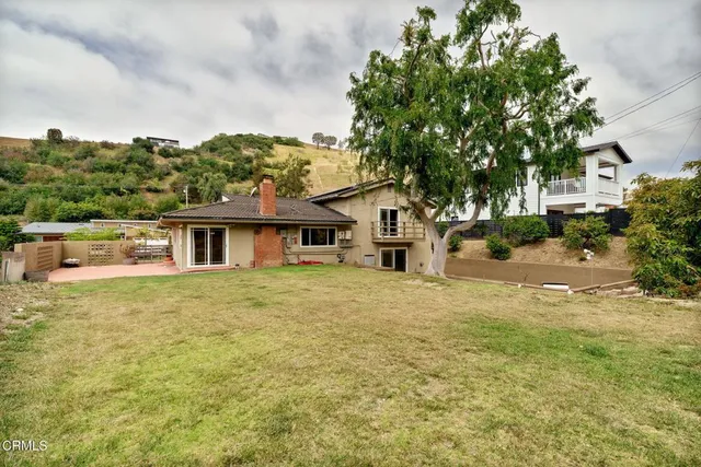 an aerial view of a house with a garden and trees